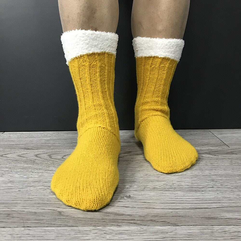 Yellow beer novelty socks, beer mug design with foam cuff, worn standing