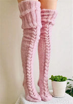 Pink cable knit thigh high socks, full length on a white background