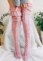 Pink cable knit thigh high socks, standing view showing the cable pattern