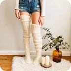 White cable knit thigh high socks, worn with denim shorts