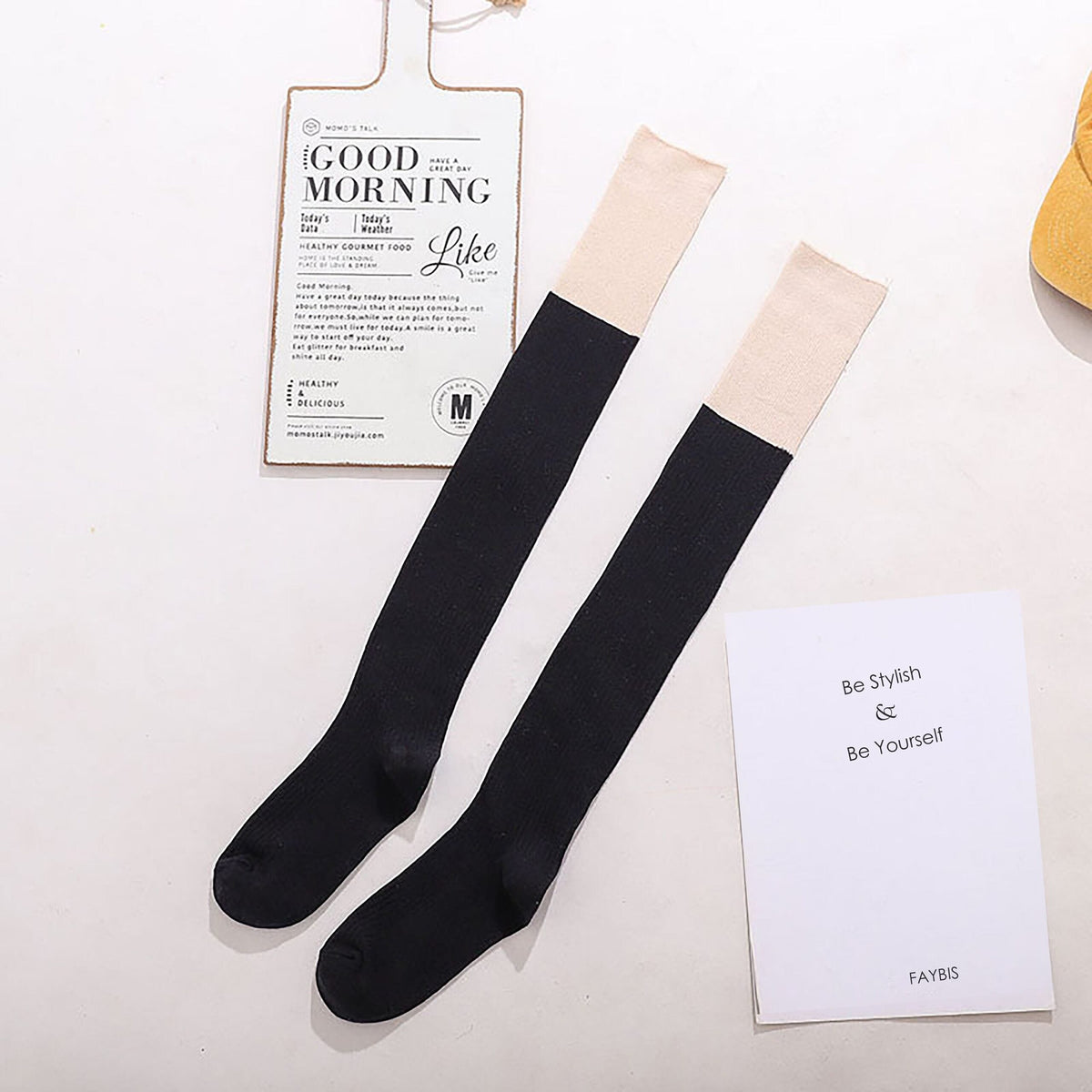 Black cotton over the knee socks with beige trim, flat lay showing the contrast cuff