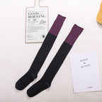 Black cotton over the knee socks with purple trim, flat lay showing the contrast cuff