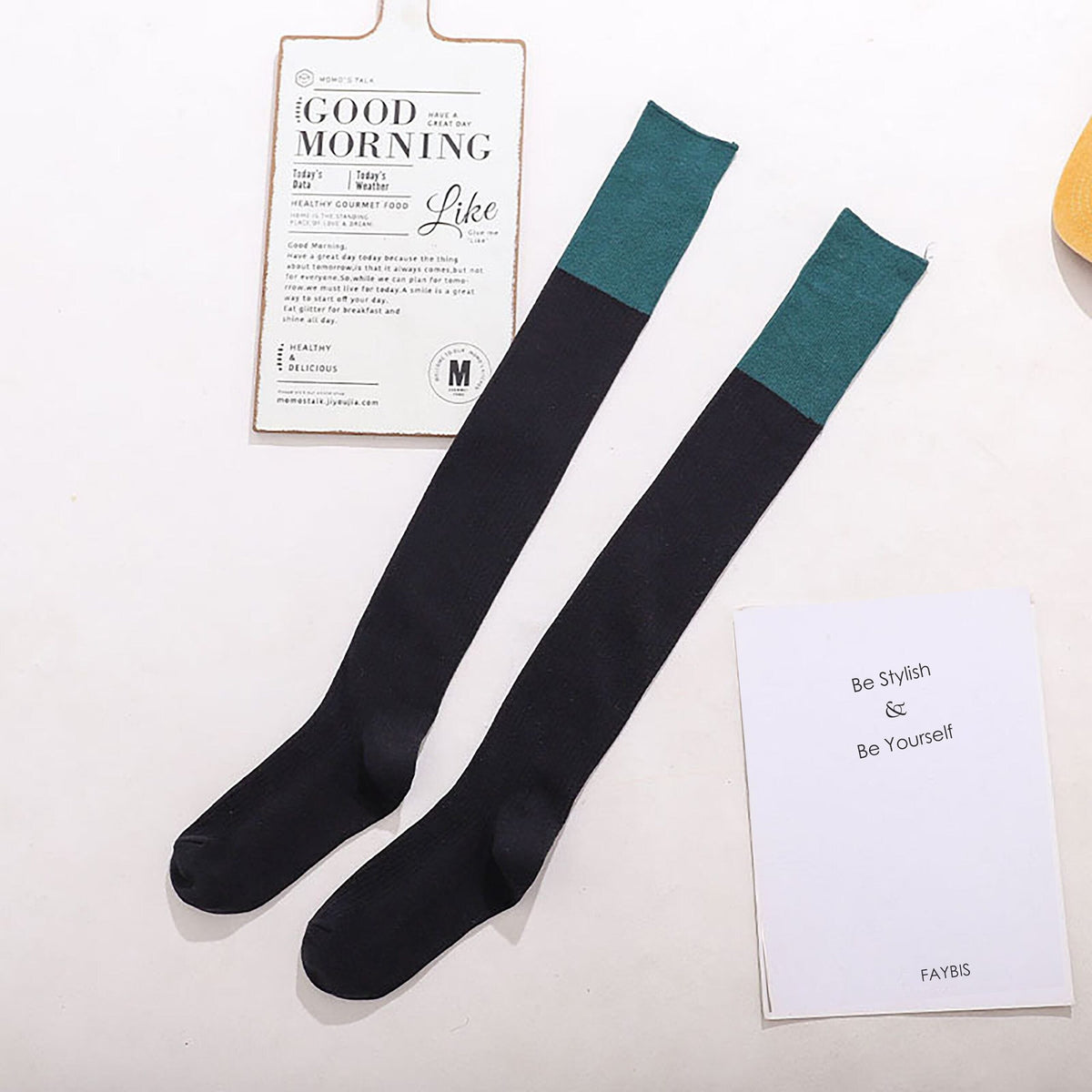 Black cotton over the knee socks with teal trim, flat lay showing the contrast cuff