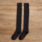 Black cotton thigh high socks, flat lay showing the ribbed knit