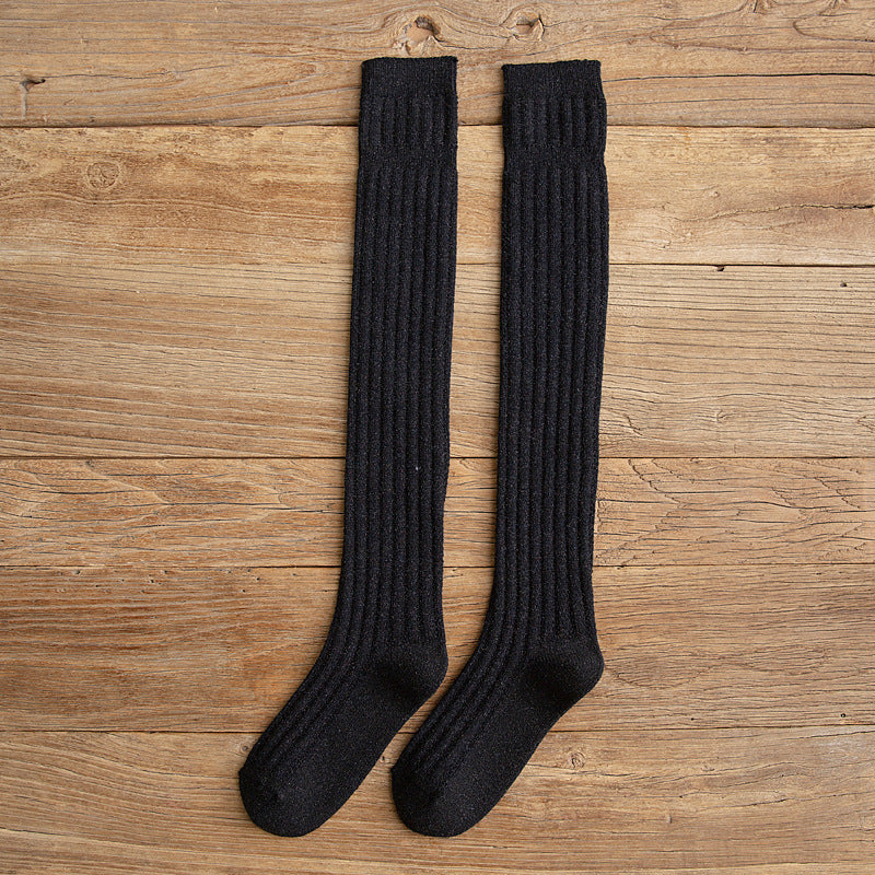 Black cotton thigh high socks, flat lay showing the ribbed knit