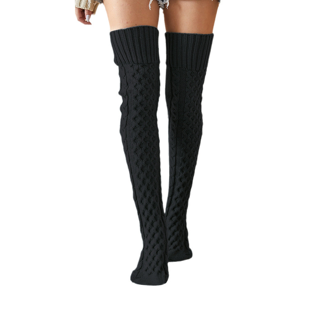Black fleece-lined knee high socks, front view on a white background
