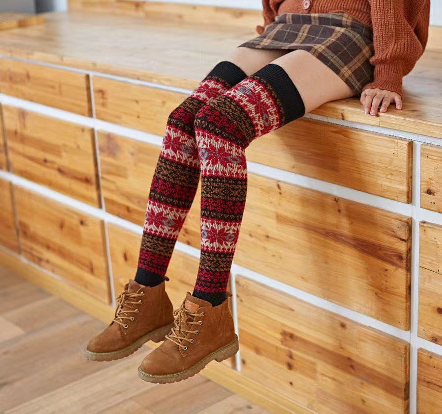 Black fuzzy thigh high leg warmers, worn with a plaid skirt and ankle boots