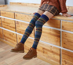 Dark blue fuzzy thigh high leg warmers, worn with a plaid skirt and ankle boots