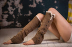 Coffee lace trim button leg warmers, worn sitting, button and lace trim detail