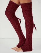 Burgundy long cable knit leg warmers, worn standing, stirrup heel