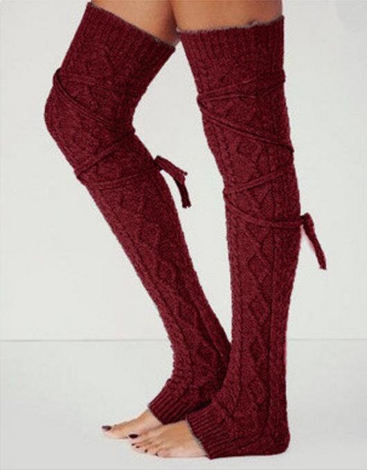 Burgundy long cable knit leg warmers, worn standing, stirrup heel