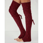 Burgundy long cable knit leg warmers, worn standing, side view