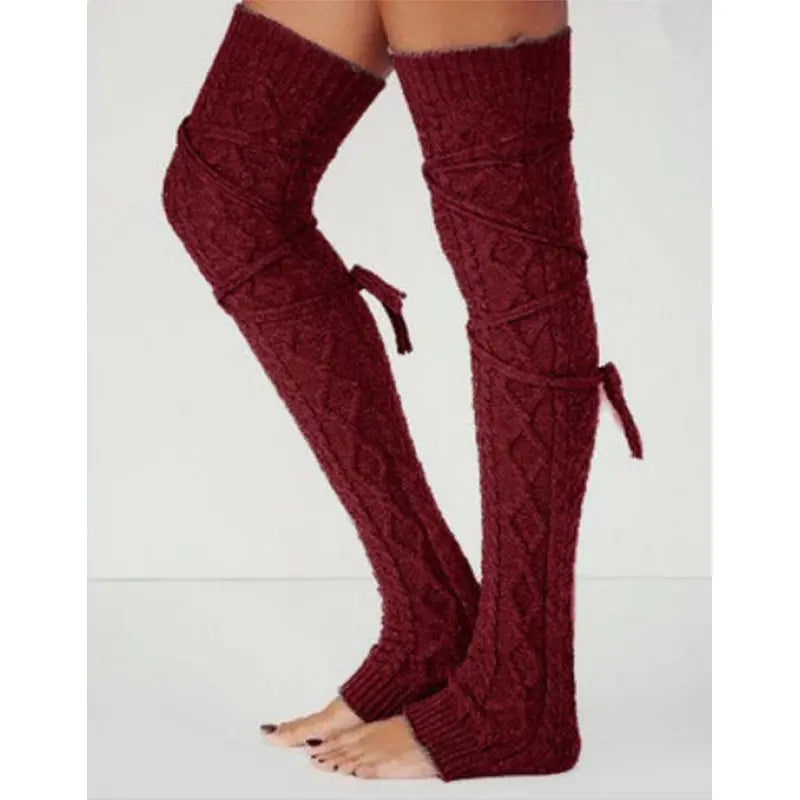 Burgundy long cable knit leg warmers, worn standing, side view