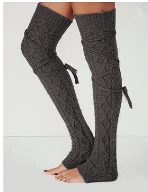 Dark gray long cable knit leg warmers, worn standing, stirrup heel