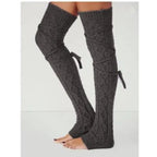 Dark gray long cable knit leg warmers, worn standing, side view