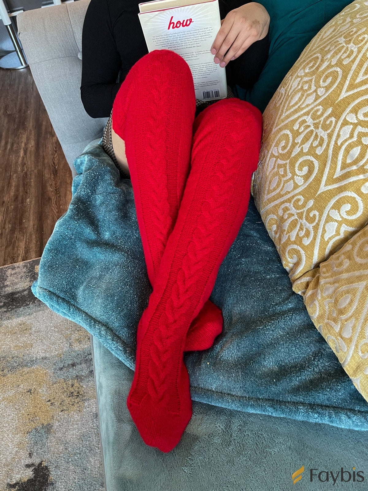 Red long knit over the knee socks, lounging on a sofa with a book