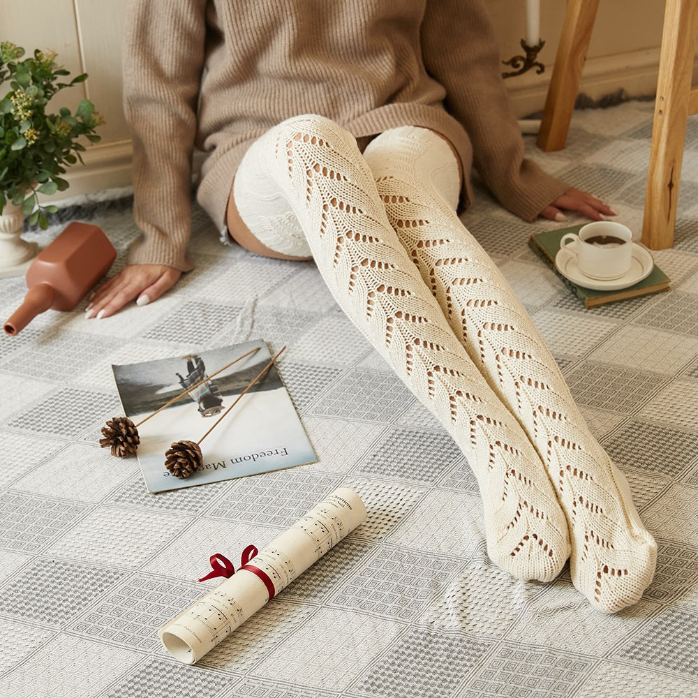 Cream mesh knit over the knee socks, worn sitting on a rug with coffee