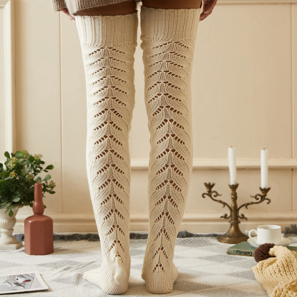 Cream mesh knit over the knee socks, worn standing in a cozy room