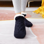 Black non-slip slipper socks, worn, sherpa-lined cuff