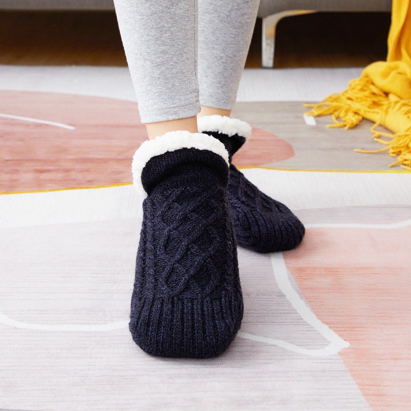 Black non-slip slipper socks, worn, sherpa-lined cuff