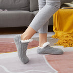 Gray non-slip slipper socks, worn walking on a rug