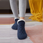 Navy blue non-slip slipper socks, worn, sherpa-lined cuff