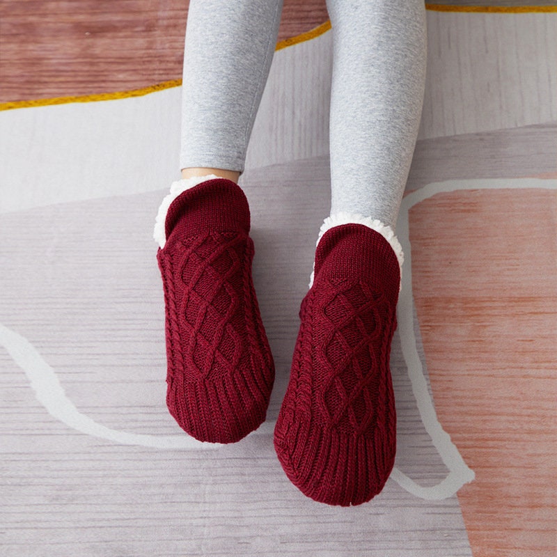 Red non-slip slipper socks, worn, sherpa-lined cuff