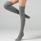 Light gray over the knee leg warmers, worn with one leg raised