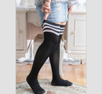 Black plus size over the knee socks with white stripes, worn with a denim skirt