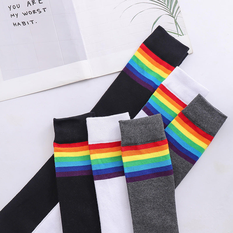 Rainbow stripe thigh high socks in all colours, black, white and gray pairs laid out together