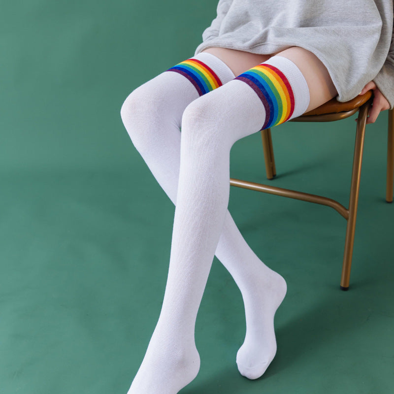 White rainbow stripe thigh high socks, worn sitting on a chair, rainbow stripe top
