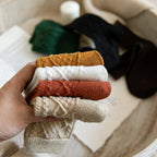 Ribbed wool blend crew socks in assorted colours, stack of pairs held in hand