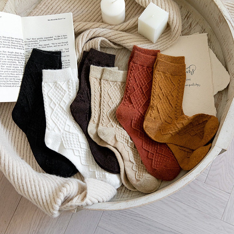 Soft knit crew socks in assorted colours, pairs in a woven basket