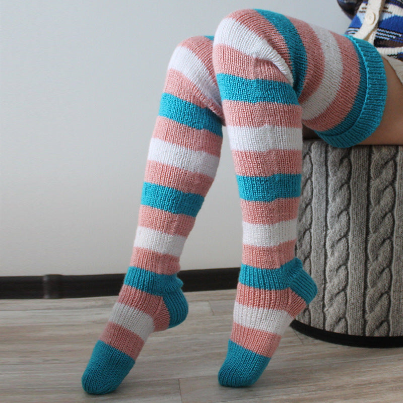 Blue and pink striped thigh high socks, worn, close-up of the knitted stripes