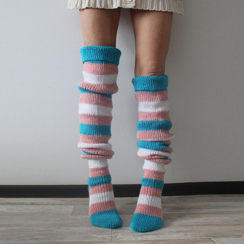 Blue and pink striped thigh high socks, slouched at the ankle