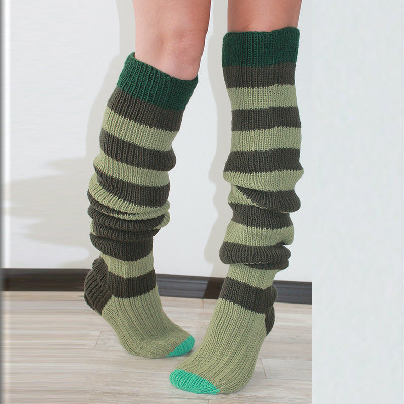 Green striped thigh high socks, slouched to show the knitted stripes