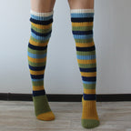 Yellow and blue striped thigh high socks, front view of the knitted stripes