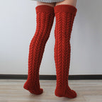 Deep red thick cable knit over the knee socks, side view of the chunky cable knit