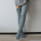 Gray thick cable knit over the knee socks, crossed legs, front view