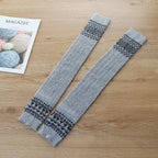 Light gray wool blend thigh high socks, flat lay showing the Fair Isle band